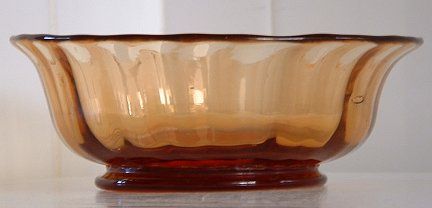 Unknown golden amber dish - side view
One of four dessert dishes. Polished pontil mark. Ribbed sides - 24 ribs. Very heavy for their size. 5" diameter. 2" high. Unknown maker, possibly Webb.
