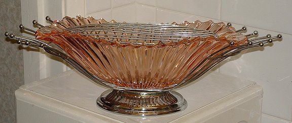 Sowerby Tyneside large flower bowl on chrome stand with metal flower grid - side view
Pink glass. Glass vase is 13" wide, 7" deep and 3" tall, chrome stand is 17" wide, 7" deep, 5" tall. Possibly Sowerby Tyneside
Keywords: Sowerby England pressed