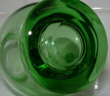 Unknown green creamer - base/pontil detail
Unknown maker. Polished pontil. 5" tall, base = 2" diameter
Keywords: mouldblown