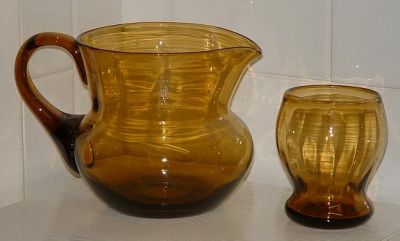 Unknown amber ribbed jug and six tumblers
No marks, polished pontils, optic ribbed bodies. 
Keywords: mouldblown