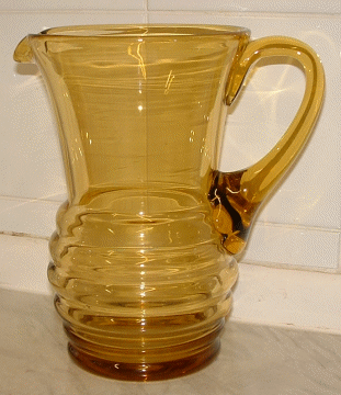Seneca tall amber jug - view 1
Amber jug with beehive shaped lower half, has polished pontil and applied handle.  Now known to be Seneca Glass Company, of Morgantown, West Virginia pattern "Streamline", design Patent number "d 60637" from 1937. [Source: Mike (butchiedog) on the Glass Message Board] [url]http://www.glassmessages.com/index.php/topic,1431.0.html[/url]
Keywords: Seneca mouldblown USA