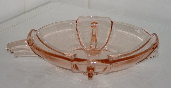 Stoelzle pink winged bowl with handle - side view
Unknown maker,  probably Czech

Now identified by Marcus Newhall on the GMB as Stoelzle, Hermannshutte, Czechoslovakia. pattern number 19265
GMB topic: [url]http://www.glassmessages.com/index.php/topic,20628.0.html[/url]

Keywords: pressed Czech Stoelzle Hermannshutte