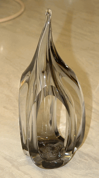Unknown glass sculpture - View 1
Hand-made (rough pontil mark on the base), has three openings cut into the sides. 6.75" tall and base is 2.5" at the widest part
