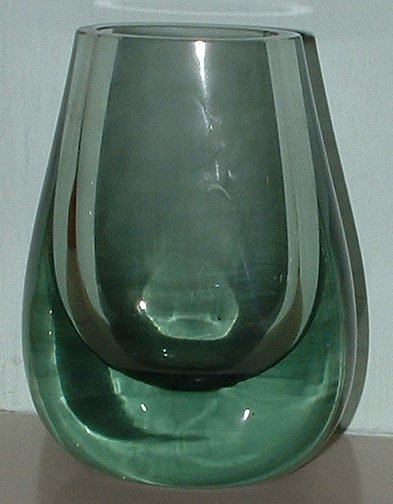 Whitefriars 9537 Ocean Green vase
Oval shaped vase. No maker's marks. Flat base, no pontil. Size: 4.5 inches (114 mm) tall. Identified as Whitefriars by Vidfletch on the [url=http://glass-time.com/messages/viewtopic.php?p=34303]GMB[/url] and shown in the 1960 Whitefriars catalogue on [url=http://www.whitefriarsorg.org/]Whitefriars[/url] website.
Keywords: Whitefriars England