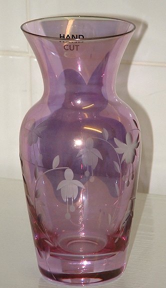 Bohemia iridescent vase
Pinky/purple iridescent vase. Is etched with a fuchsia pattern. No marks, but matches ones seen labelled as Bohemia Glass. 
Keywords: Czech