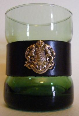 Unknown tumbler with leather band & badge
